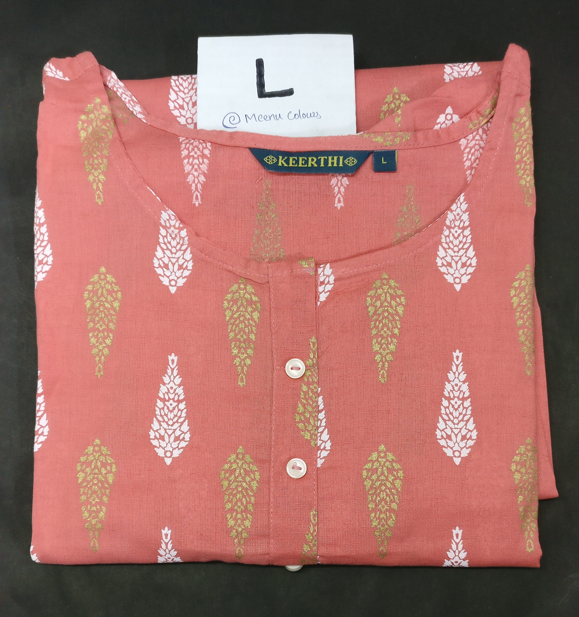 pink cotton kurti with white and gold leaf prints, round neckline, buttoned placket, and 3/4th sleeves.