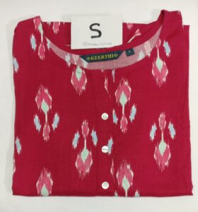 Red rayon kurti with multicolor printed motifs, round neckline, buttoned placket, and 3/4thsleeves.